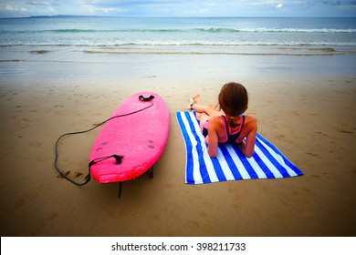 Noosa Main Beach, seaside themes and people sun tanning or baking on the beach. Australian Beaches