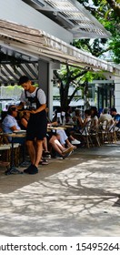 Noosa, Queensland, Australia October 29th 2019: Waiter Serving Drinks At Pavement Cafe On Hastings Street.