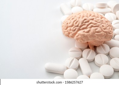 Nootropics use to improve memory and neural function, smart drugs and cognitive enhancers conceptual idea with brain and pills isolated on white background with copy space