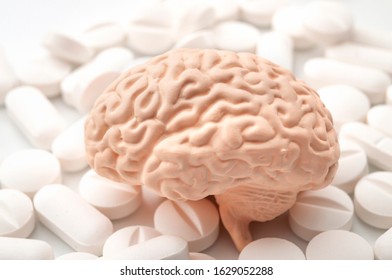 Nootropics use to improve memory and neural function, smart drugs and cognitive enhancers conceptual idea with brain and pills isolated on white background