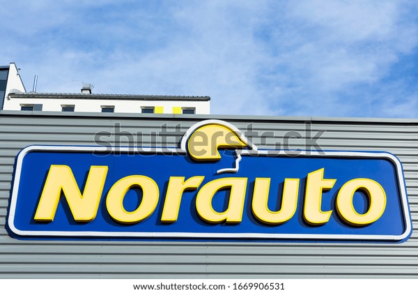 Norauto Groupe brand logo on bright
blue sky background. Car parts shop and service station located on
its dealer building in Lyon, France - February 23,
2020