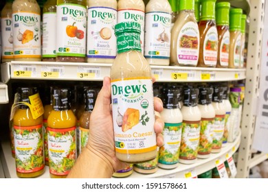 Norco, California/United States - 11/18/2019: A Hand Holds A Bottle Of Drew's Organics Romano Caesar Salad Dressing At A Local Grocery Store.