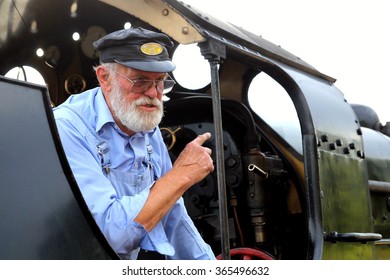 NORDEN STATION, DORSET, UK - AUGUST 08, 2015: Veteran Train Driver Explains The Workings Of His Steam Locomotive. 