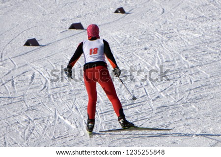 Nordic skier in red in white winter nature full of snow. Sport active photo