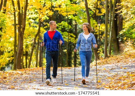 Nordic walking - active people working out outdoor 