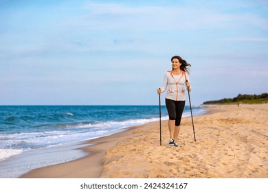 Nordic walking - beautiful woman exercising on beach  - Powered by Shutterstock