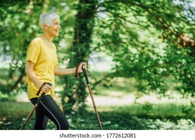 Nordic Walking Exercise. Active Mature Woman Enjoying The Nature