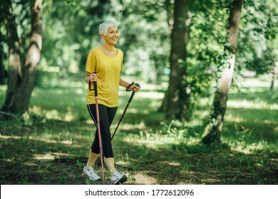 Nordic Walking Exercise. Active Mature Woman Enjoying The Nature