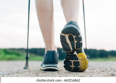 Nordic Walking In Summer. Closeup Of Woman's Legs With Nordic Walking Poles