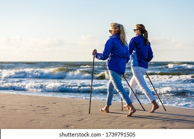 Nordic Walking - Two Women Working Out On Beach
