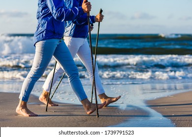 Nordic Walking - Two Women Working Out On Beach
