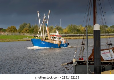 Norfolk, UK - 10.25.2021:  A Fishing Trawler Returns Along The Great Ouse River To Its Harbour Near King's Lynn