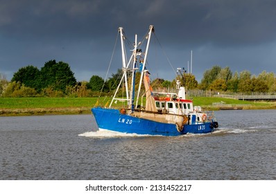 Norfolk, UK - 10.25.2021:  A Fishing Trawler Returns Along The Great Ouse River To Its Harbour Near King's Lynn