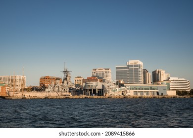 Norfolk, VA, US-November 13, 2021:  View Of The Skyline Of The City On The Waterfront With Iconic Skyscrapers, Restaurants And Naval Ships.