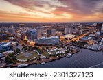 Norfolk, Virginia, USA downtown city skyline from over the Elizabeth River at dusk.
