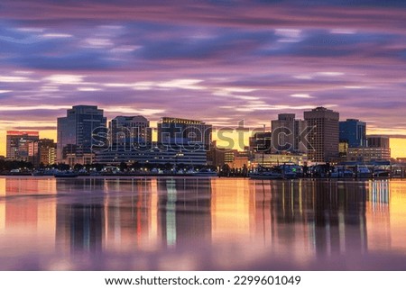 Norfolk, Virginia, USA downtown city skyline with dramatic morning clouds on the Elizabeth River.