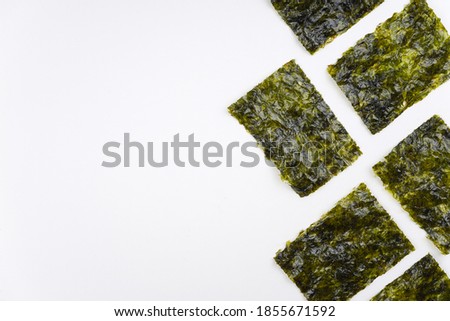 Nori chips on white background. Sushi, recipe, menu, seaweed, iodine concept. Top view, flat lay, copy space