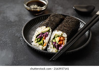 Nori Roll On Black Background. Next To Soy Sauce