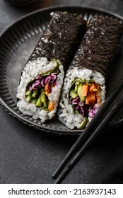 Nori Roll On Black Background. Next To Soy Sauce