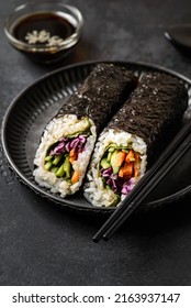 Nori Roll On Black Background. Next To Soy Sauce