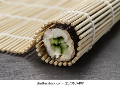 Nori Sushi Roll In A Bamboo Mat. Close Up. Grey Background