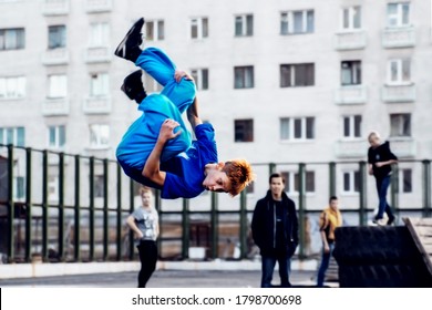 Norilsk, Russia - August, 28, 2016: Young Teenager Jumps And Does Somersaults. Parkour On The Street.