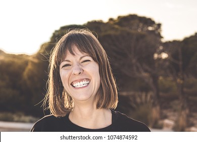 Normal Brunette Girl Smiling. Woman With A Smile On A Sunset. Happy Expression