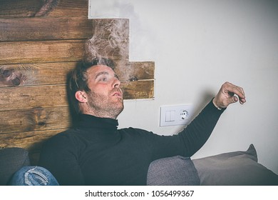Normal guy smoking on the couch at home. Vintage and social networking photography