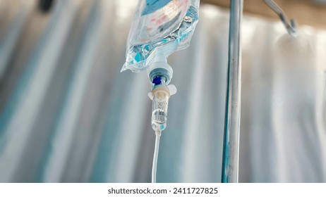 Normal saline solution (NSS) bag and infusion pump for patient in the patient room at the hospital, Saline drip in hospital room. Vitamin fluid intravenous drop saline drip hospital room. - Powered by Shutterstock