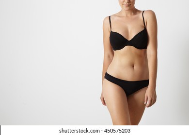 normal woman's body wears swimsuit on a white background