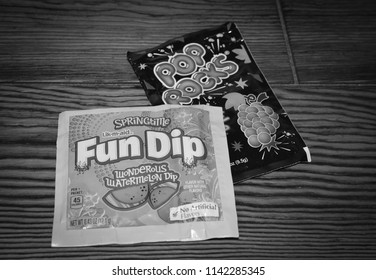 Norman, OK July 21, 2018 A Close Up Black And White Photo Of Fun Dip And Pop Rock Candy On A Wooden Table 