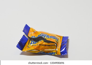 Norman, OK March 9, 2019 An Empty Bite Size Butterfinger Candy Bar Wrapper On A White Studio Background