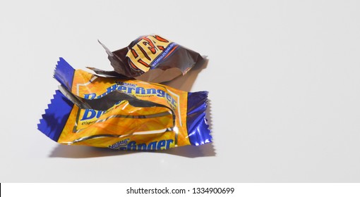 Norman, OK March 9, 2019 An Empty Bite Size Butterfinger And Heath Candy Bar Wrapper On A White Studio Background
