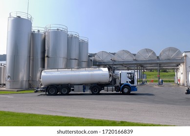 Normandy, France, April 2008.
Dairy Plant. Milk Tanker Truck In Front Of Milk Storage Tank