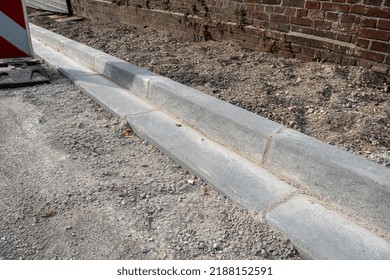 Normandy, France, JAugust 2022. Sidewalk and gutter repair in a street. Installation of cement curbs