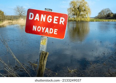 Normandy, France, March 2022. Sign Danger Drowning On A Pond In A Village. Prevention Of Accidental Flooding In Rivers And Water Reservoirs