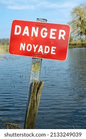 Normandy, France, March 2022. Sign Danger Drowning On A Pond In A Village. Prevention Of Accidental Flooding In Rivers And Water Reservoirs