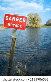 Normandy, France, March 2022. Sign Danger Drowning On A Pond In A Village. Prevention Of Accidental Flooding In Rivers And Water Reservoirs