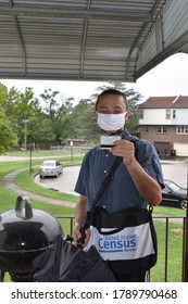 Norristown, PA/USA-August 4, 2020:  Handsome Young Gentleman Enumerator Census Taker Stands In The Doorway Point Of View To Show His Badge.  He Wears A Mask And A Census Bag Over His Shoulder.