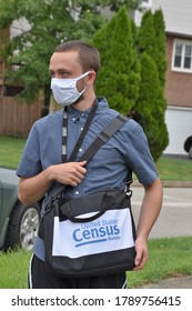 Norristown, PA/USA-August 4, 2020:  Young Man Enumerator Census Taker Heads Toward The Next House To Help With The Decennial 2020 Census.  He Wears A Mask, Badge And Computer Back Over His Shoulder.