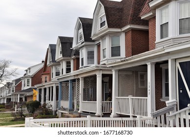 Norristown, PA/USA-March 14, 2020:  A Block Of Two Story Row Homes With Gothic Style Influence In A Quiet Lower Middle Class America Neighborhood, While People Hunker Down During The Pandemic.