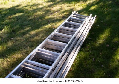 Norrtalje, Sweden - August 19 2020:
Metal ladders perched on the lawn. 
