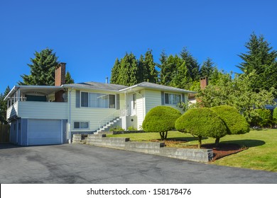 North American Family House With Asphalt Driveway And Stairway To The Entrance