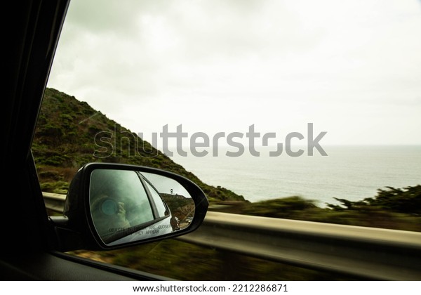 The North California road in\
forest, after rain time. Driving near the ocean. Car on the\
highway