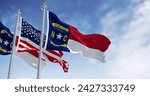 North Carolina state flags waving with american flag. North Carolina is a state in the Southeastern region of the S. Rippled fabric. 3d illustration render. Selective focus. Rippling fabric