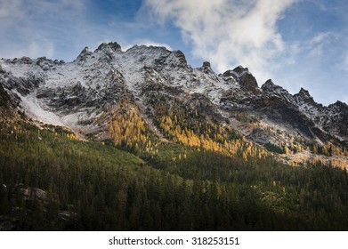North Cascades Mountains. Some spectacular scenery seen from Highway 20, also called the North Cascades Highway, during a lovely autumn day. Snow capped peaks and colorful larches dot the landscape.