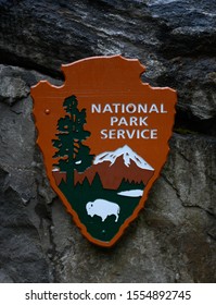 North Cascades National Park, United States: July 27, 2019: National Park Service Logo Hangs On Stone Wall