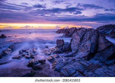 North Devon Sunset Over Lundy Island And The Low Tide Rocks At Woolacombe Beach