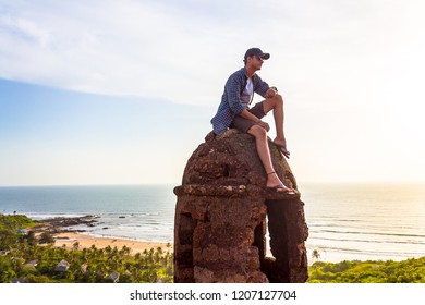 North Goa, Goa / India - October 20 2018: A guy sitting on a rock in Chapora fort. 