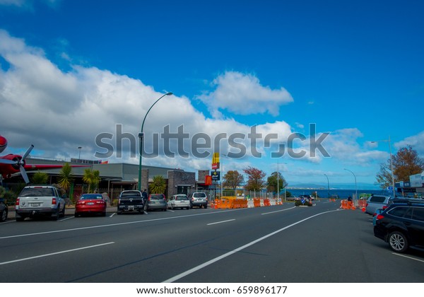 NORTH ISLAND, NEW\
ZEALAND- MAY 18, 2017: Taupo is a town on the shore of Lake Taupo\
in the centre of the North Island of New Zealand. Some cars parked\
outside of a stores